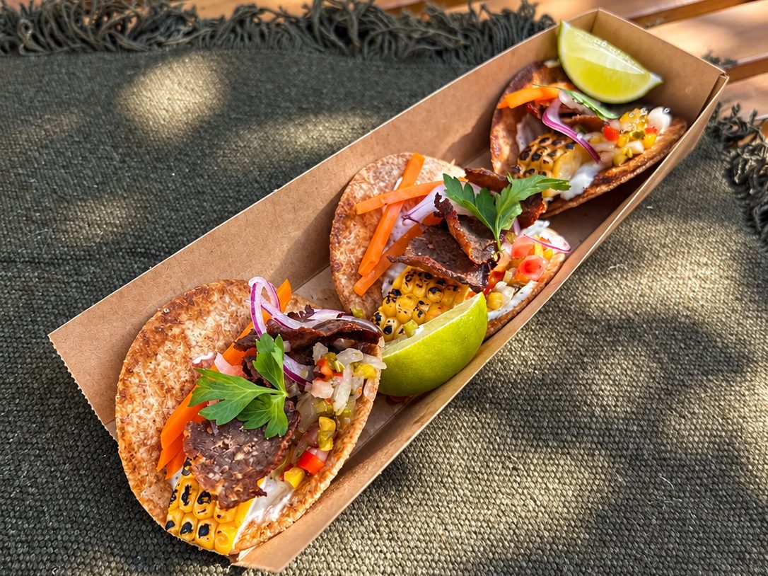 Tacos de kebab com milho, cebola roxa e lima, numa caixa de street food